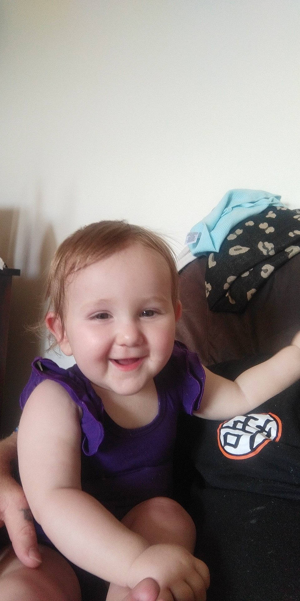 Esmae joined the competition — help win amazing prizes! baby, baby_products, cap, child, elbow, electric_blue, face, fun, gesture, happy, joy, person, personal_protective_equipment, portrait_photography, room, sitting, sleeve, smile, t_shirt, toddler