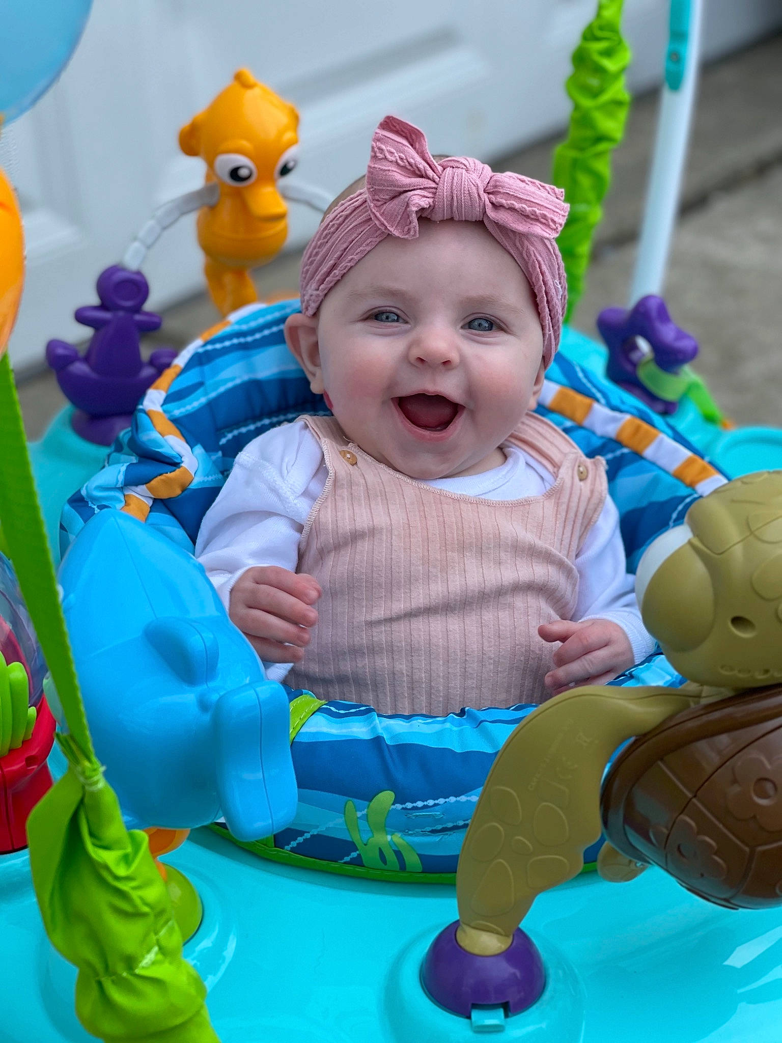 Becca joined the competition — help win amazing prizes! baby, baby_playing_with_toys, baby_products, baby_toddler_clothing, blue, child, event, fun, green, happy, headwear, leisure, person, pink, purple, recreation, riding_toy, smile, toddler, toy