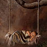 baby, sleeping, blanket, swing, tree_branch, fur, knitted, cozy, peaceful, portrait, infant, child, nature, woodland, soft_texture, brown_background, rest, cute, newborn, calm