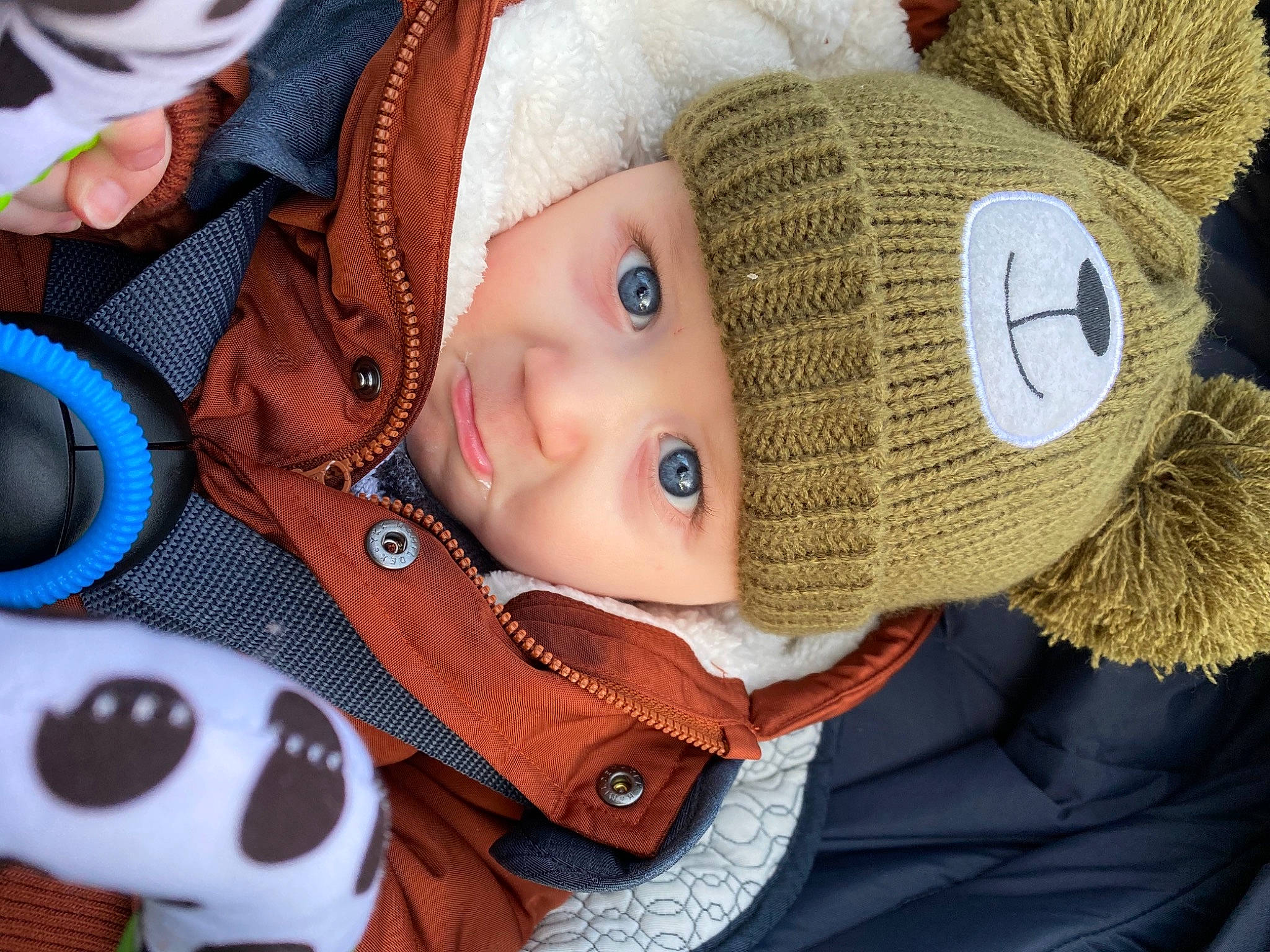 Colby is registered to the contest to win money with this photo: baby, cap, cheek, cool, eye, face, facial_expression, hat, head, headgear, headwear, human_body, jacket, mouth, nose, outerwear, person, skin, textile, toddler