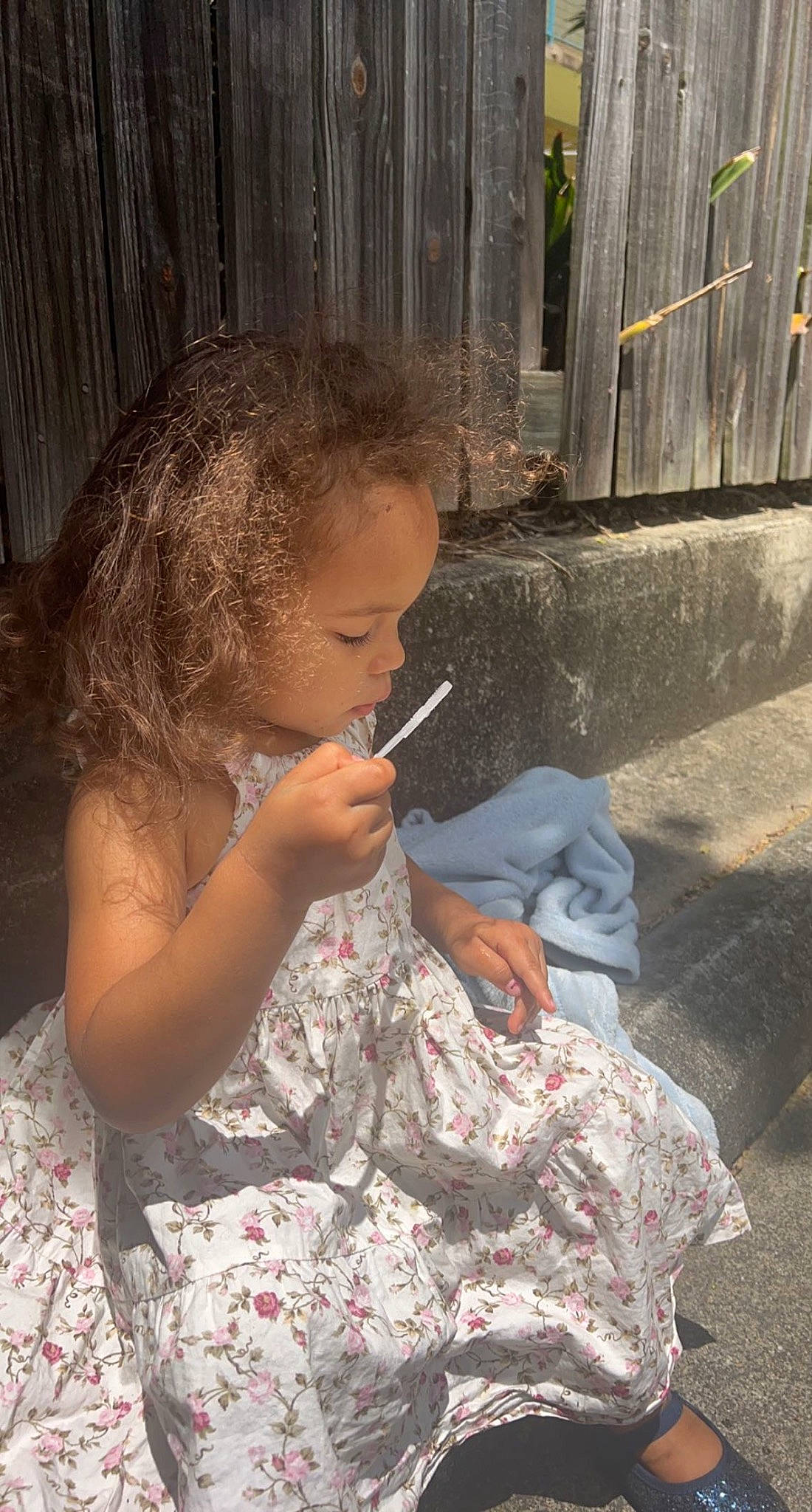 Ellayna is registered to the contest to win money with this photo: cheek, child, chin, dress, eye, hair, head, mouth, person, sitting, soil, toddler, visual_arts, wood