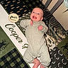 baby, infant, crib, blanket, onesie, smiling, face, child, pattern, animal_print, plaid, milestone, four_months, happy, lying_down, cozy, indoor, person, cute, home