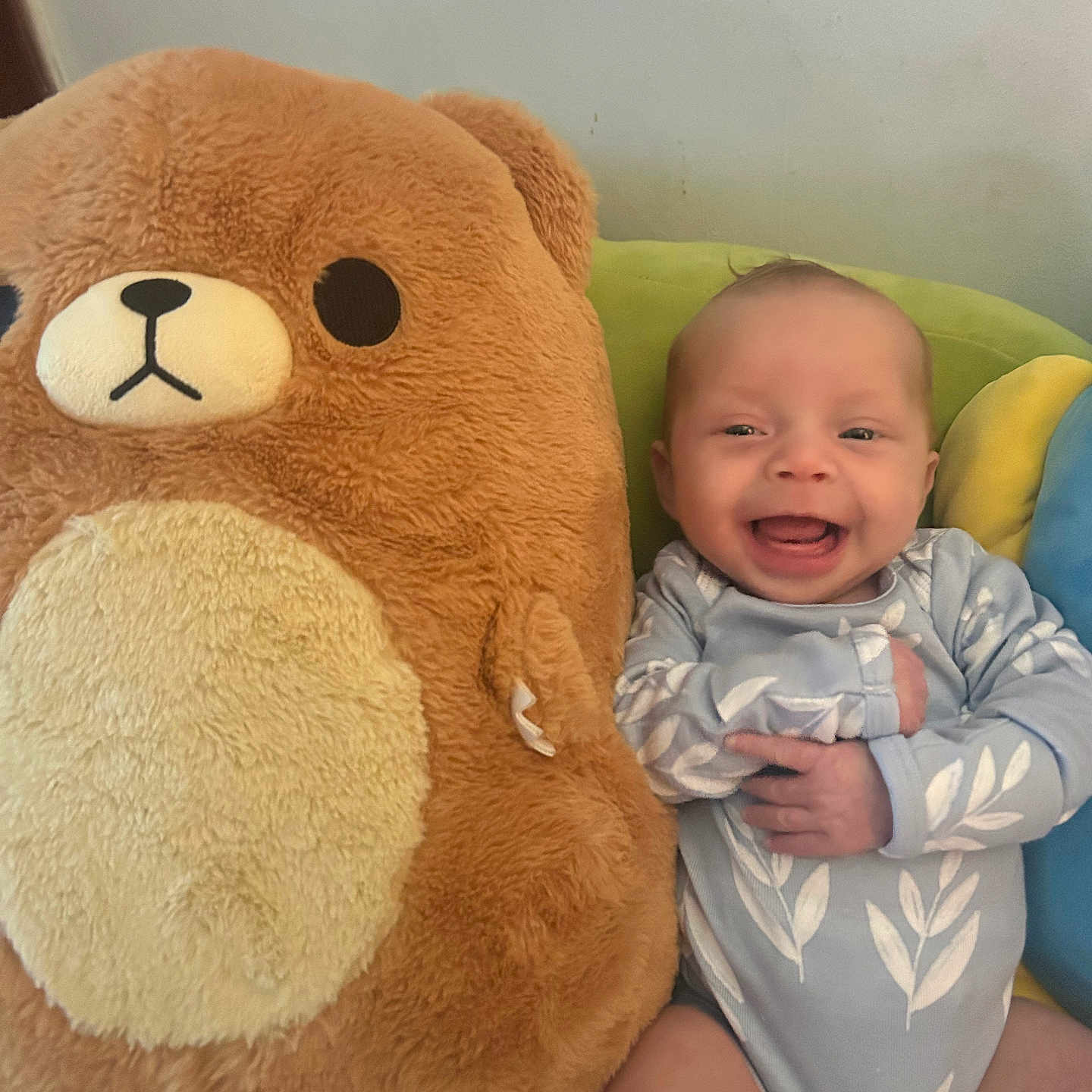 Adelia joined the competition — help win amazing prizes! baby, bear, blue, child, comfort, couch, cute, green, happy, indoor, infant, onesie, person, plush_toy, portrait, seated, smiling, soft_toy, toy, yellow