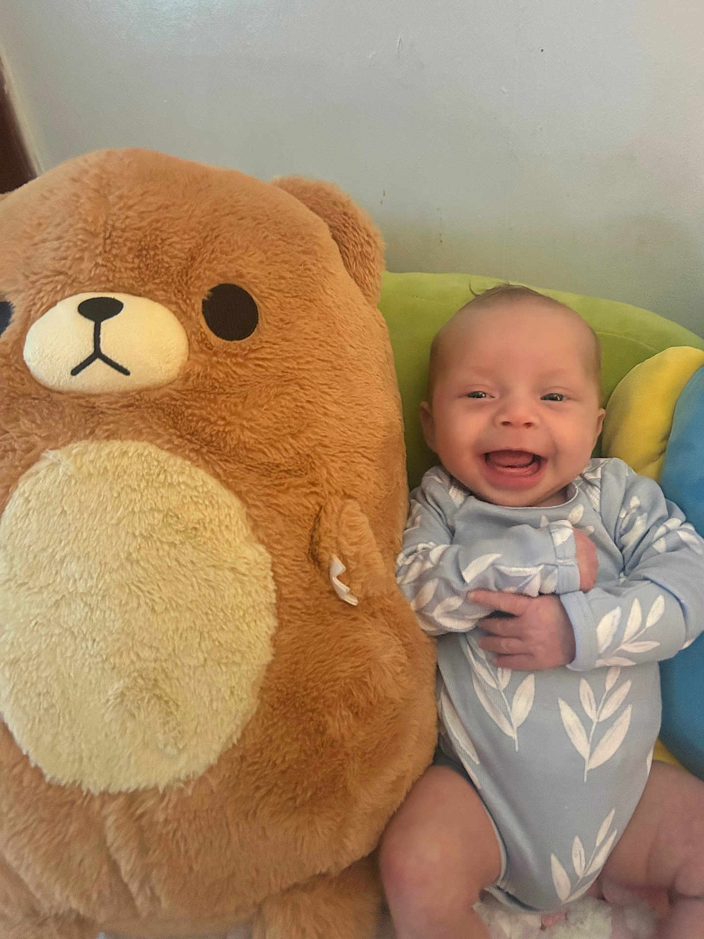 Adelia joined the competition — help win amazing prizes! baby, smiling, plush_toy, bear, onesie, infant, happy, couch, soft_toy, child, cute, indoor, comfort, seated, toy, blue, green, yellow, person, portrait