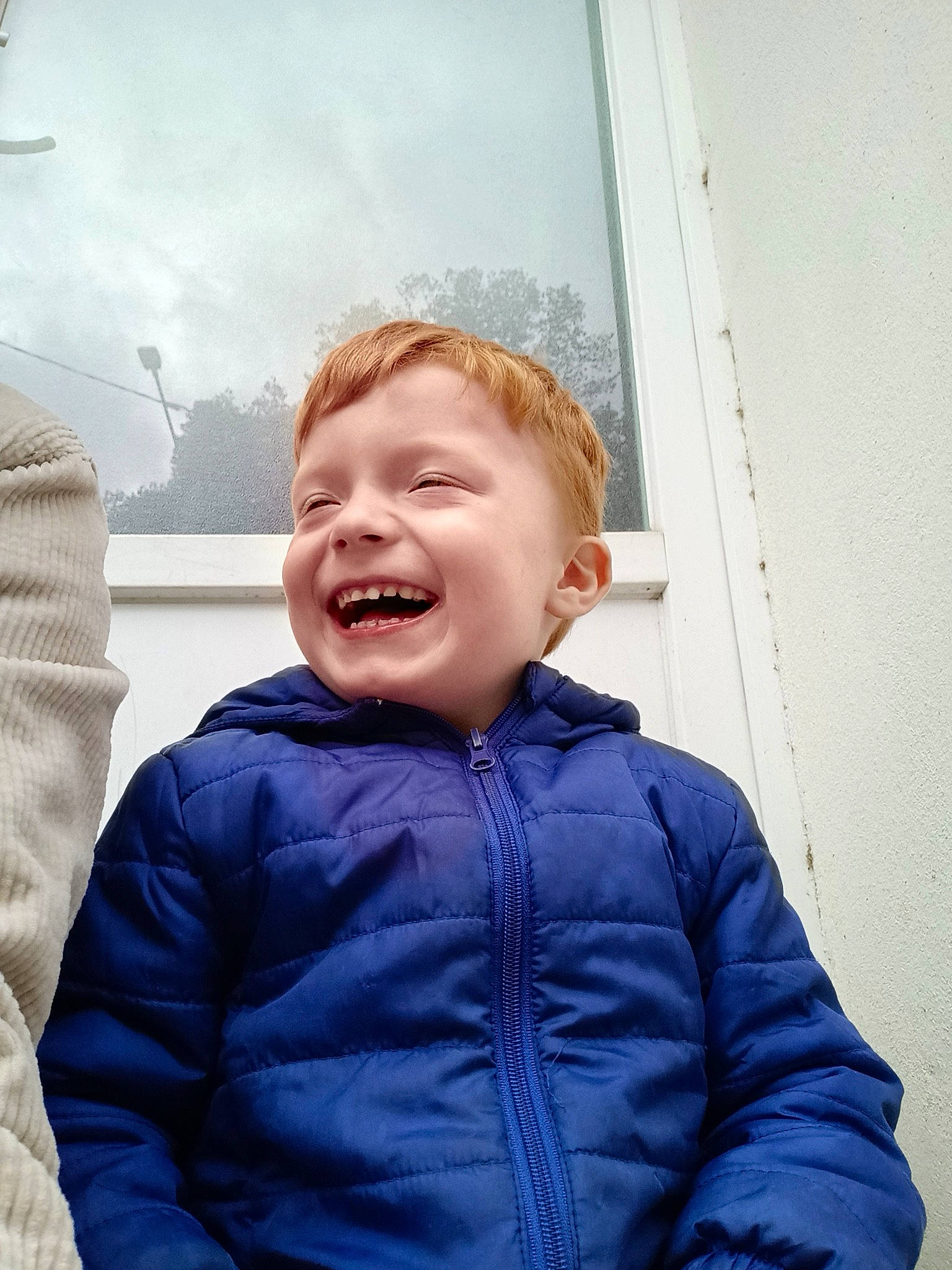 Logan participe au concours pour gagner de l'argent avec cette photo : child, denim, electric_blue, flash_photography, fun, fur, gesture, happy, hood, jacket, joy, laugh, mouth, outerwear, person, portrait_photography, sitting, sky, sleeve, smile