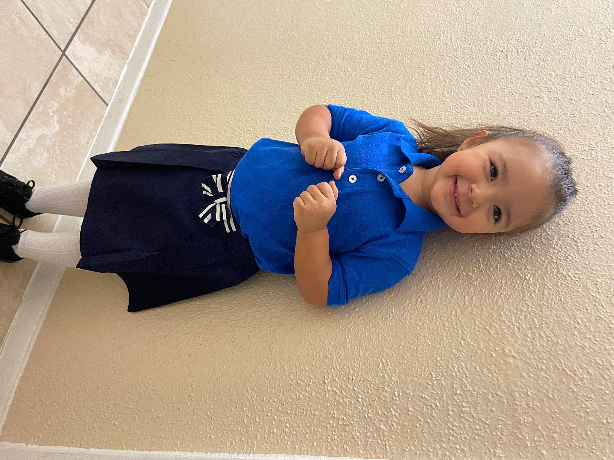 Katherine is registered to the contest to win money with this photo: baby, baby_toddler_clothing, comfort, denim, elbow, electric_blue, floor, flooring, foot, human_body, human_leg, joy, knee, person, room, sitting, sleeve, smile, sportswear, t_shirt