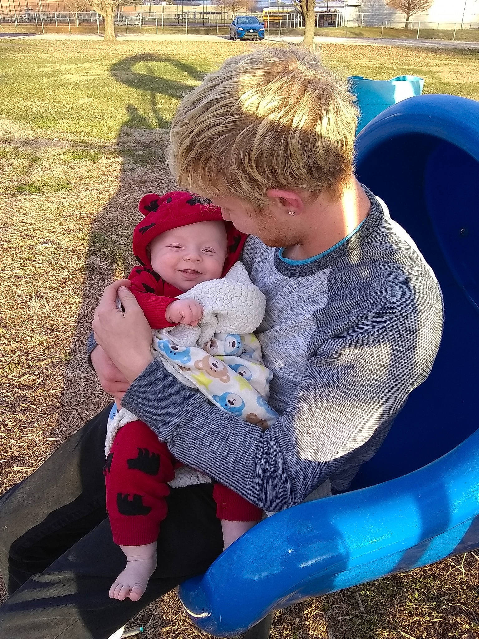 Zaidyn is registered to the contest to win money with this photo: child, day, fun, girl, infant, interaction, people, person, plant, play, playground, product, recreation, red, sibling, sitting, smile, toddler, vacation