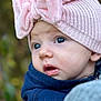 baby, child, face, hat, pink, bow, knit, blue_clothing, portrait, outdoor, curious, closeup, infant, soft_focus, cute, warm_clothing, person, headwear, expression, fall_background