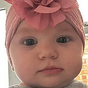 Amelia joined the competition — help win amazing prizes! baby, brick_wall, calm_expression, cheeks, chubby_cheeks, closeup, clothing, cute, eyes, flower, forehead, headband, headwrap, indoor, infant, mouth, nose, pink, portrait, window