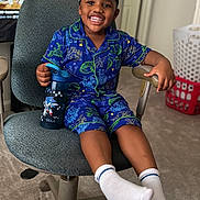 Daceon joined the competition — help win amazing prizes! child, smiling, pajamas, dinosaur, blue, chair, water_bottle, sonic_the_hedgehog, indoor, carpet, laundry_basket, television, cartoon, happy, socks, headwear, person, furniture, room, home