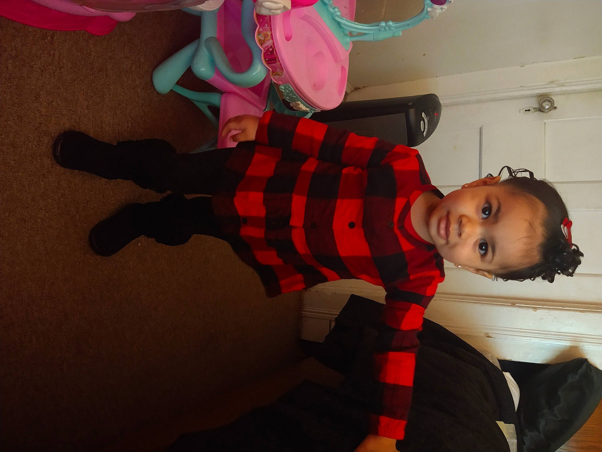 Ahzara is registered to the contest to win money with this photo: baby, carmine, child, costume, fictional_character, flooring, fun, happy, holiday, magenta, pattern, person, pink, plaid, red, room, sleeve, smile, sock, toddler