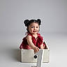 baby, child, girl, pigtails, red_dress, crate, number_one, birthday, celebration, studio, smiling, sitting, portrait, cute, infant, isolated, white_background, happy, one_year_old, decorative
