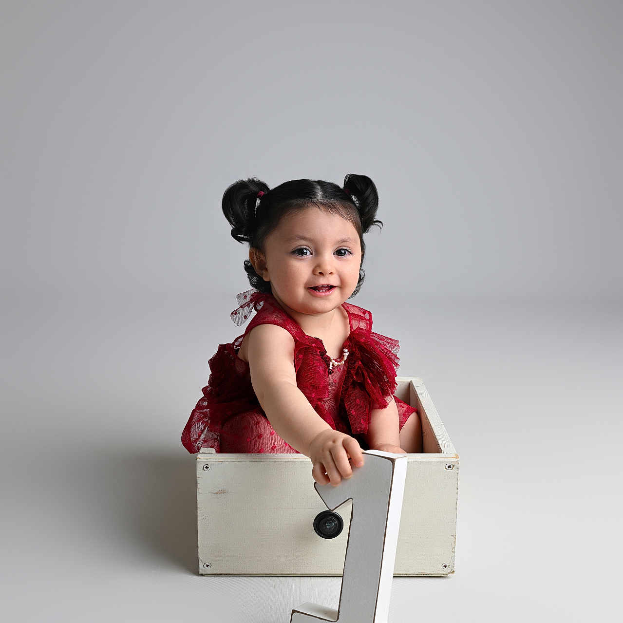 Gamze participe au concours pour gagner de l'argent avec cette photo : baby, child, girl, pigtails, red_dress, crate, number_one, birthday, celebration, studio, smiling, sitting, portrait, cute, infant, isolated, white_background, happy, one_year_old, decorative