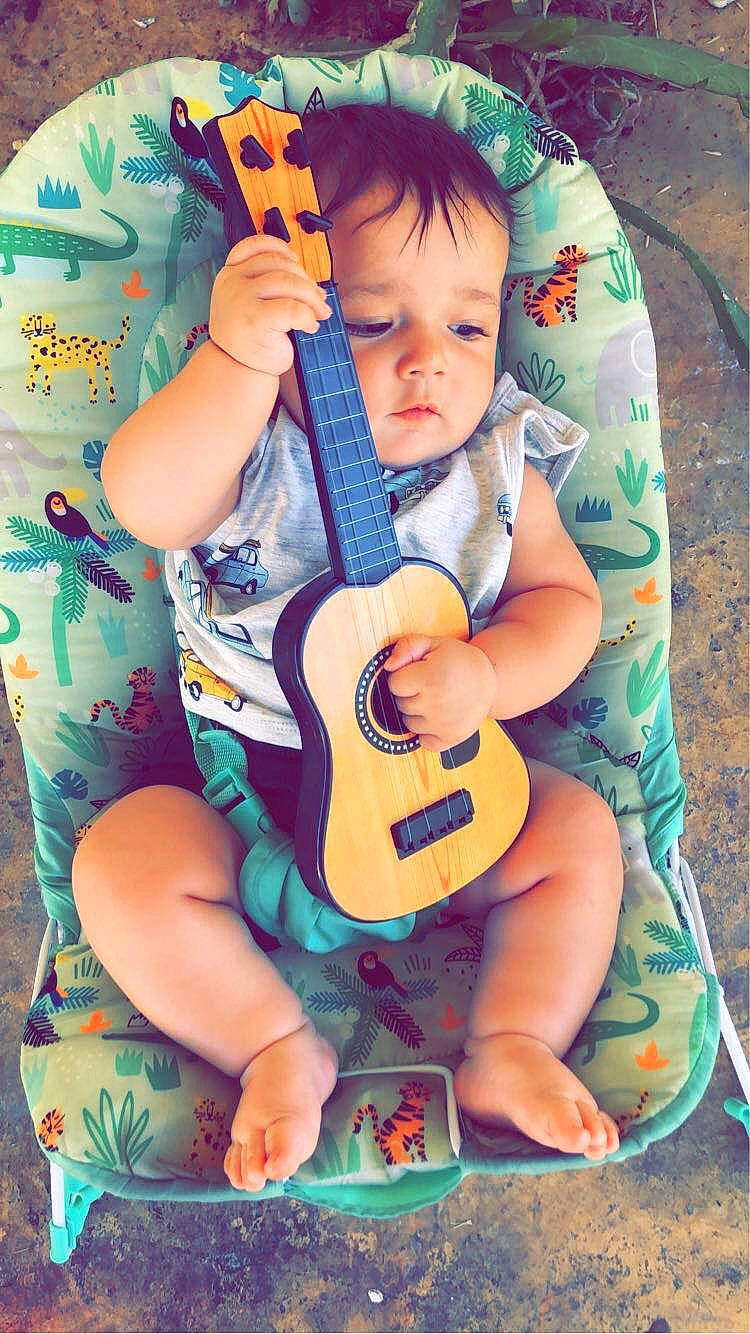 Dasan is registered to the contest to win money with this photo: baby, baby_toddler_clothing, eye, grass, guitar, guitar_accessory, guitarist, happy, head, human_body, musical_instrument, musician, nail, person, plucked_string_instruments, skin, string_instrument, string_instrument_accessory, t_shirt, toddler
