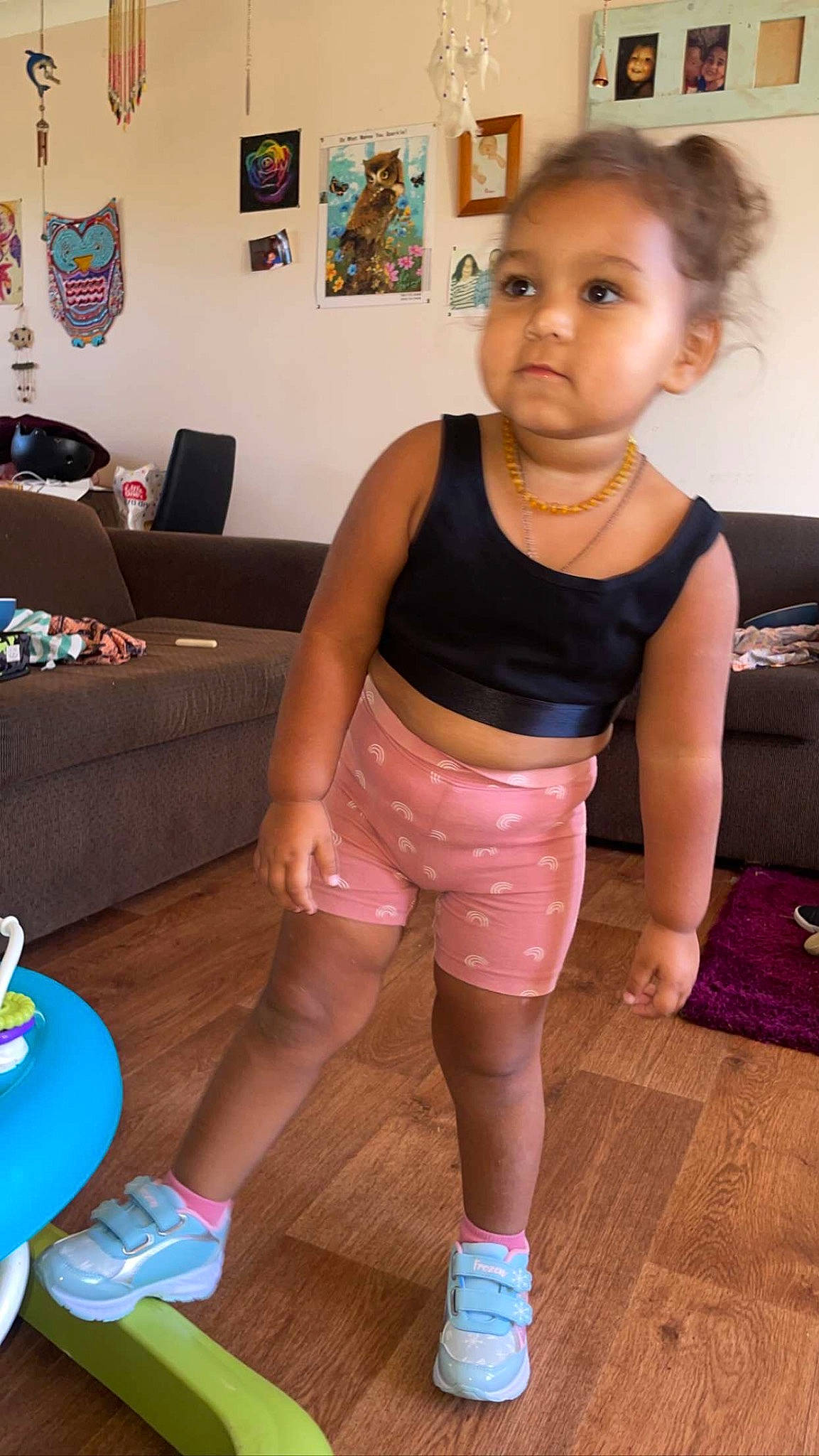 Quinn is registered to the contest to win money with this photo: abdomen, active_tank, chest, child, elbow, floor, flooring, fun, hardwood, human_leg, joint, joy, knee, leisure, neck, person, picture_frame, room, thigh, toddler