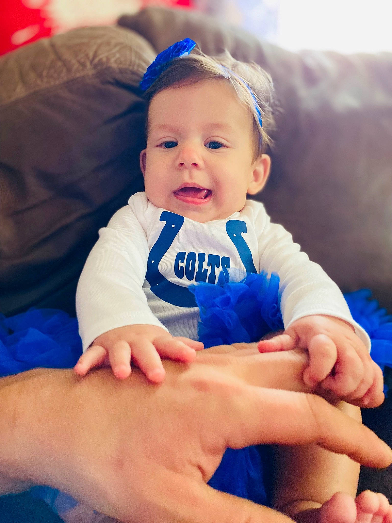 Kyla is registered to the contest to win money with this photo: arm, baby, baby_toddler_clothing, blue, electric_blue, eye, face, finger, flash_photography, gesture, hand, happy, head, nail, person, photograph, skin, sleeve, smile, thumb