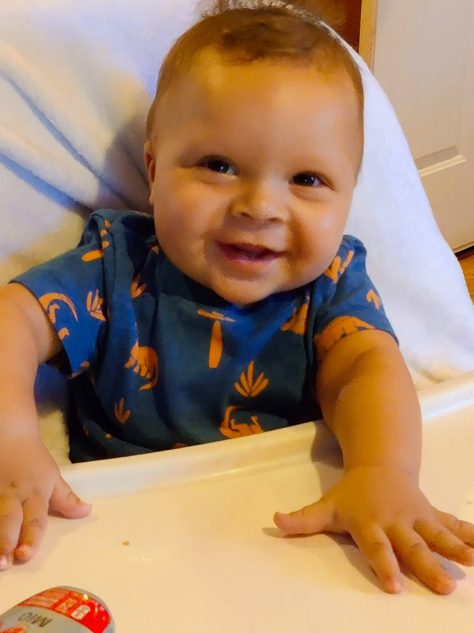 Jasiah is registered to the contest to win money with this photo: baby, baby_toddler_clothing, cheek, child, face, finger, flooring, fun, hairstyle, happy, head, joy, mouth, nose, person, sitting, skin, sleeve, smile, t_shirt