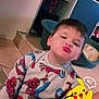 Tiago participe au concours pour gagner de l'argent avec cette photo : child, boy, pajamas, spiderman, indoor, floor, tile, pout, face, smile, cartoon, pikachu, digital_sticker, toy, pet_bed, home, furniture, cute, playful, expression