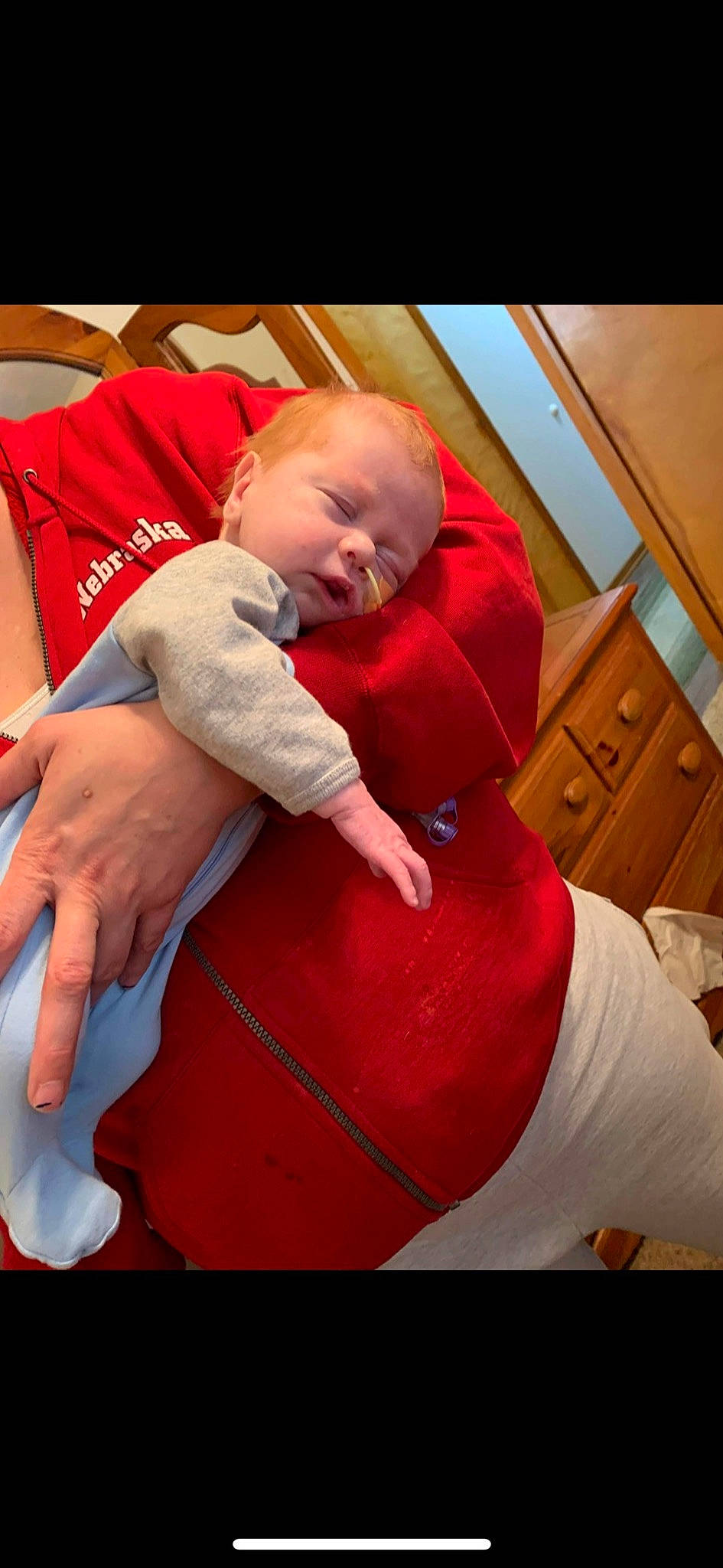 Levi is registered to the contest to win money with this photo: abdomen, baby, baby_toddler_clothing, cabinetry, cheek, chest, chest_of_drawers, comfort, flooring, fun, happy, human_leg, knee, lap, mouth, person, textile, thigh, thumb, toddler