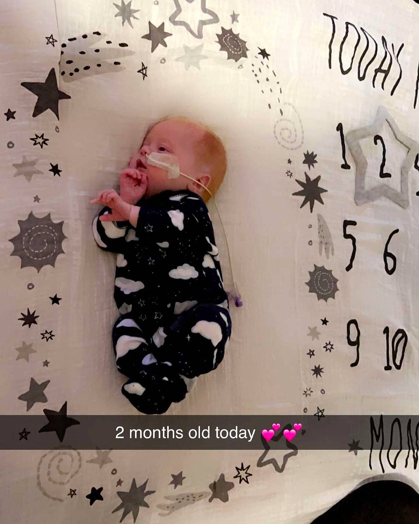 Levi is registered to the contest to win money with this photo: art, arthropod, baby, baby_products, baby_toddler_clothing, child, font, happy, insect, organism, paper, paper_product, pattern, person, pink, plant, room, textile, toddler, visual_arts