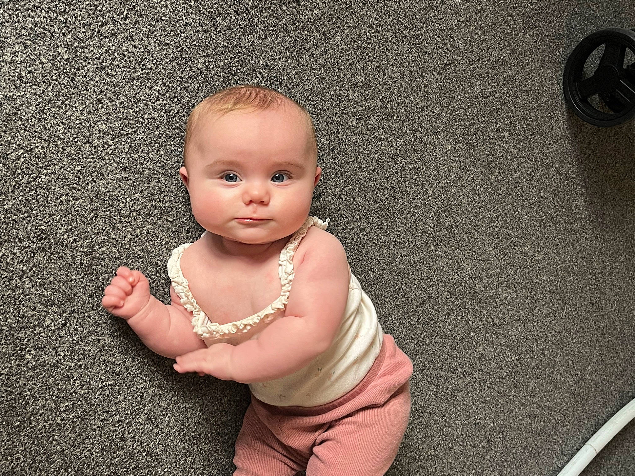Poppy is registered to the contest to win money with this photo: art, baby, baby_toddler_clothing, cheek, chest, child, flash_photography, floor, flooring, fun, gesture, happy, human_leg, metal, nail, person, room, sitting, thumb, toddler