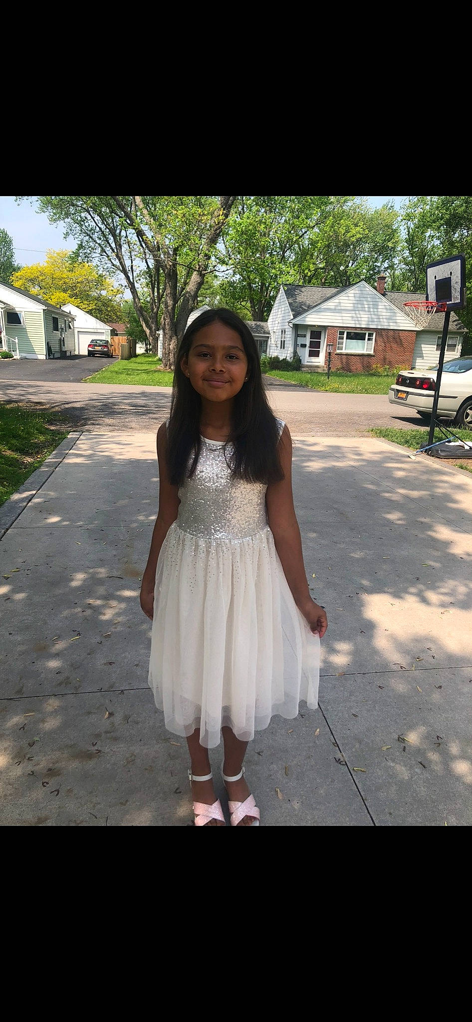 Gianna is registered to the contest to win money with this photo: bangs, day_dress, face, fashion_design, fawn, formal_wear, grass, happy, jewellery, joy, knee, long_hair, outerwear, person, plaid, plant, shoulder, sleeve, smile, tree