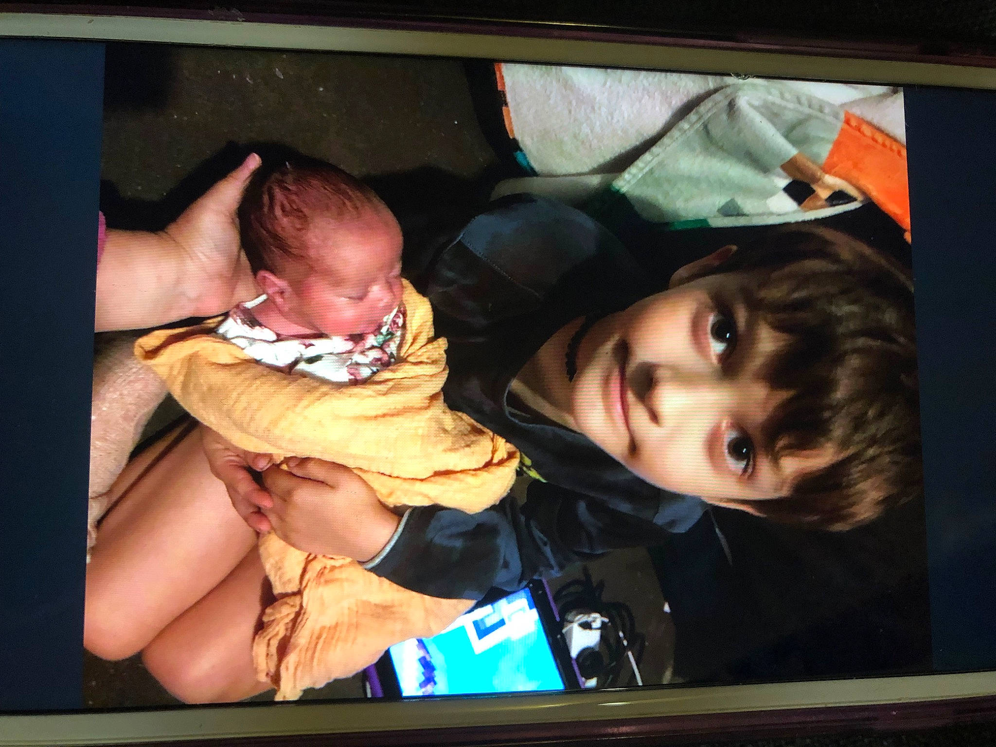 Callum is registered to the contest to win money with this photo: baby, baby_products, baby_toddler_clothing, cheek, child, comfort, display_device, fun, happy, joy, lap, mouth, multimedia, person, photo_caption, picture_frame, product, room, sitting, smile