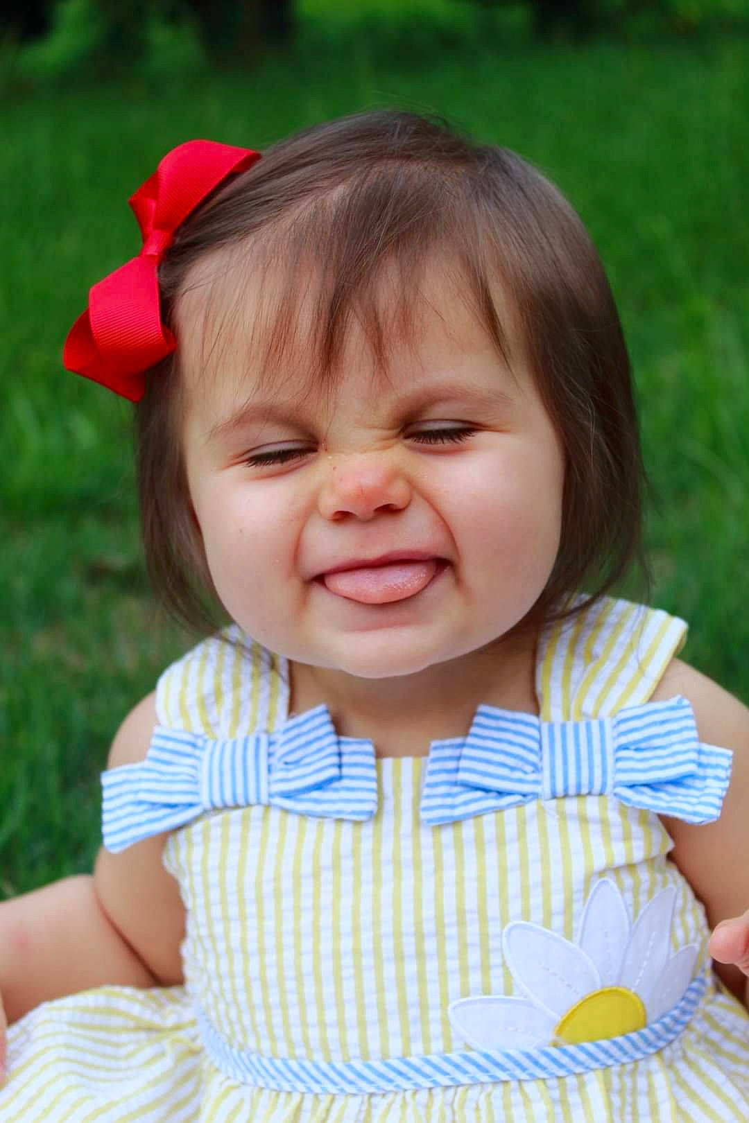 Addison joined the competition — help win amazing prizes! baby, baby_toddler_clothing, cheek, child, dress, facial_expression, finger, grass, happy, iris, light, lip, nose, person, photograph, pink, skin, sleeve, summer, toddler