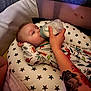 Arlen-Ray joined the competition — help win amazing prizes! baby, bottle, feeding, tattoo, pillow, star_pattern, pajamas, infant, hand, bed, sleeping_area, indoor, child, person, relaxing, milk, cute, comfort, resting, nursery