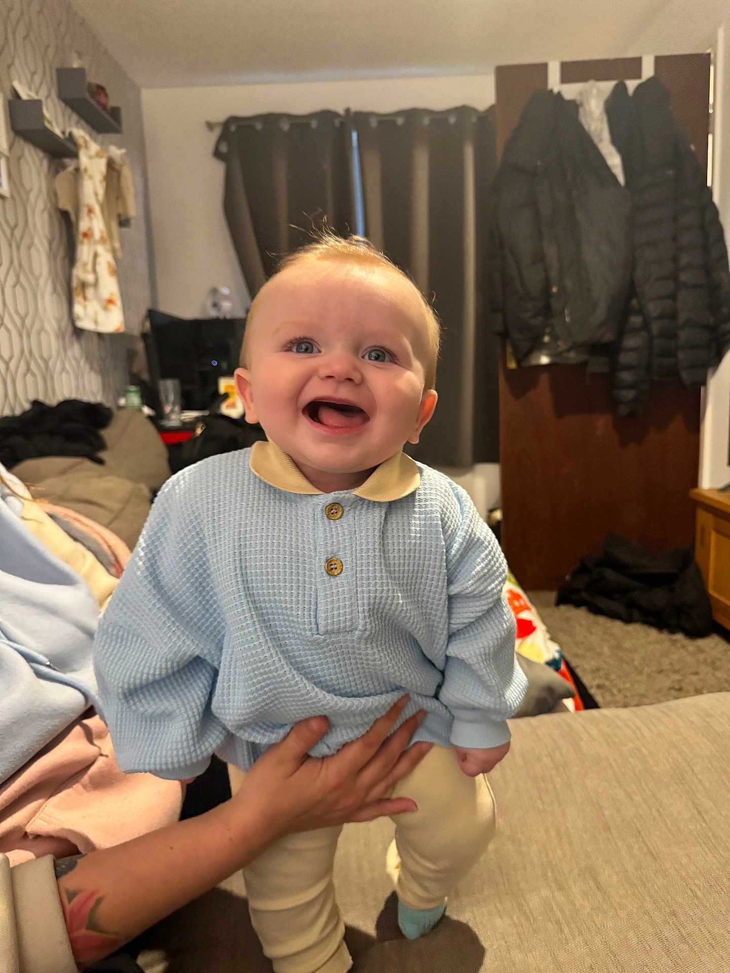 Arlen-Ray joined the competition — help win amazing prizes! baby, child, smile, happy, indoor, person, clothing, sweater, hand, furniture, sofa, curtains, room, door, coat, carpet, tattoo, patterned_wallpaper, footwear, portrait