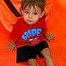 boy, brown_hair, candid, child, colorful, hands, happy, indoor, legs, looking_at_camera, orange_tent, play tent, portrait, red_shirt, safe, shorts, sitting, spiderman, toddler, wide_eyes