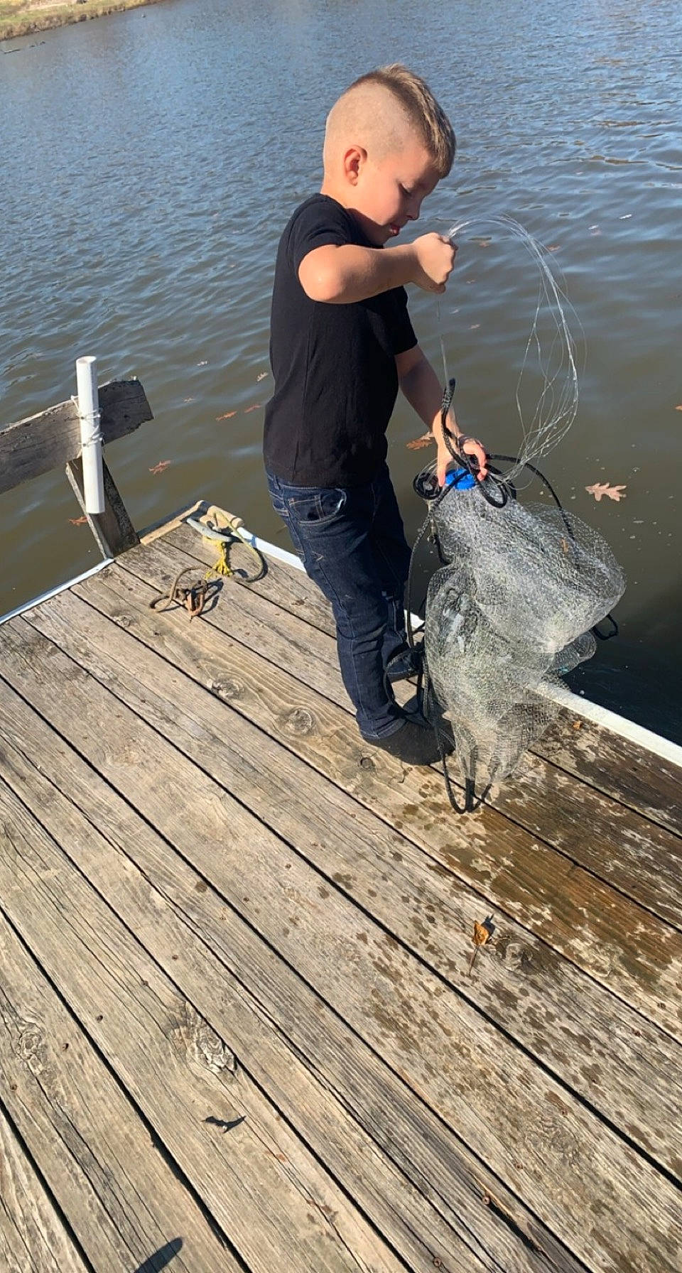 Titan is registered to the contest to win money with this photo: body_of_water, dock, fish, fisherman, fishing, fishing_net, fishing_rod, happy, hardwood, lake, leisure, ocean, people_in_nature, person, plank, recreation, recreational_fishing, shorts, vacation, water