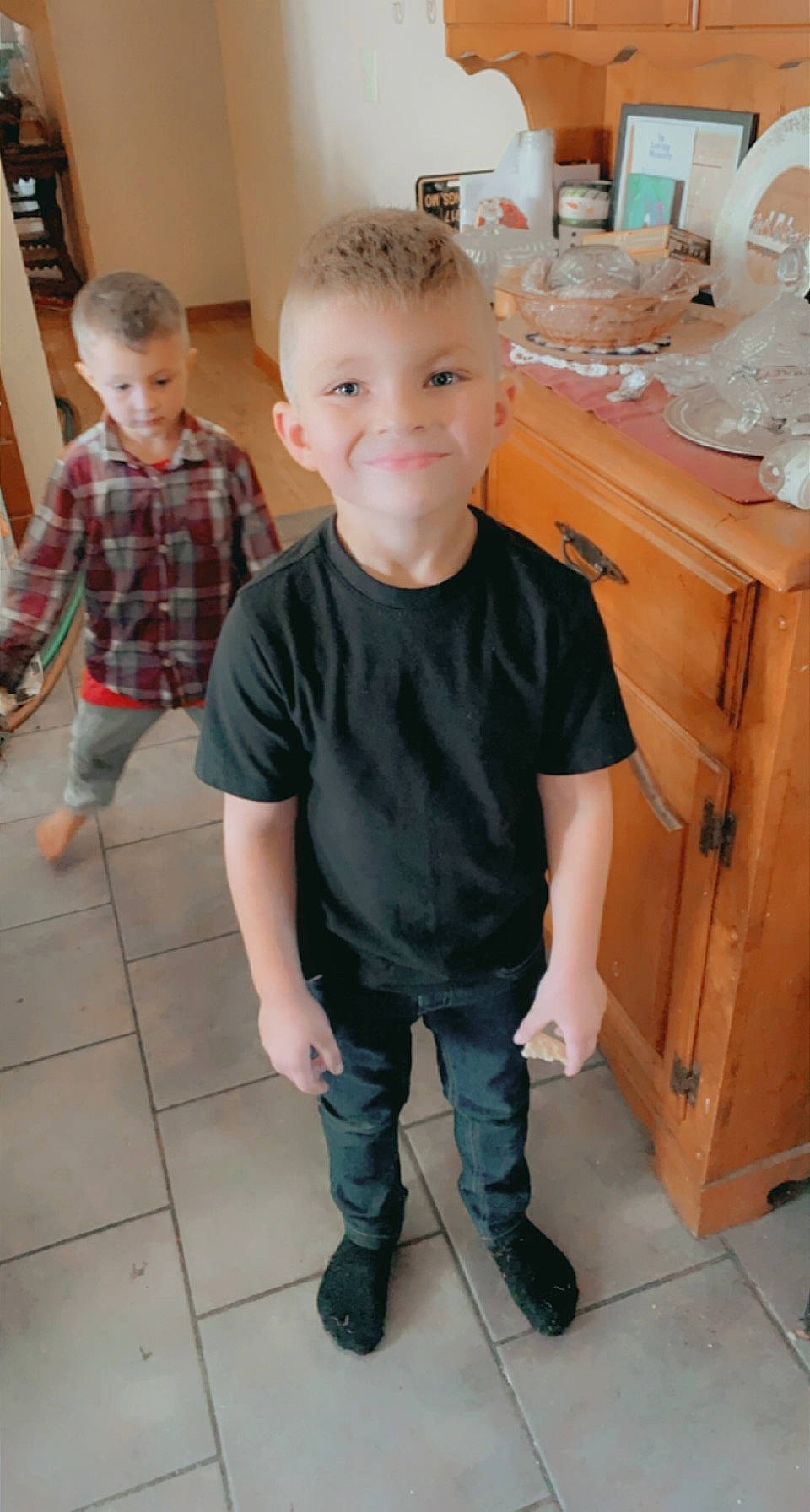 Titan is registered to the contest to win money with this photo: baby_toddler_clothing, child, face, flooring, fun, hardwood, head, joint, joy, leg, pattern, person, plaid, room, shoe, skin, sleeve, smile, standing, t_shirt