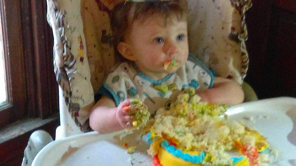 Ayden is registered to the contest to win money with this photo: baby, baby_toddler_clothing, chair, cheek, child, comfort_food, cuisine, event, food, food_craving, fun, icing, ingredient, person, plate, recipe, sugar_cake, sweetness, table, tableware