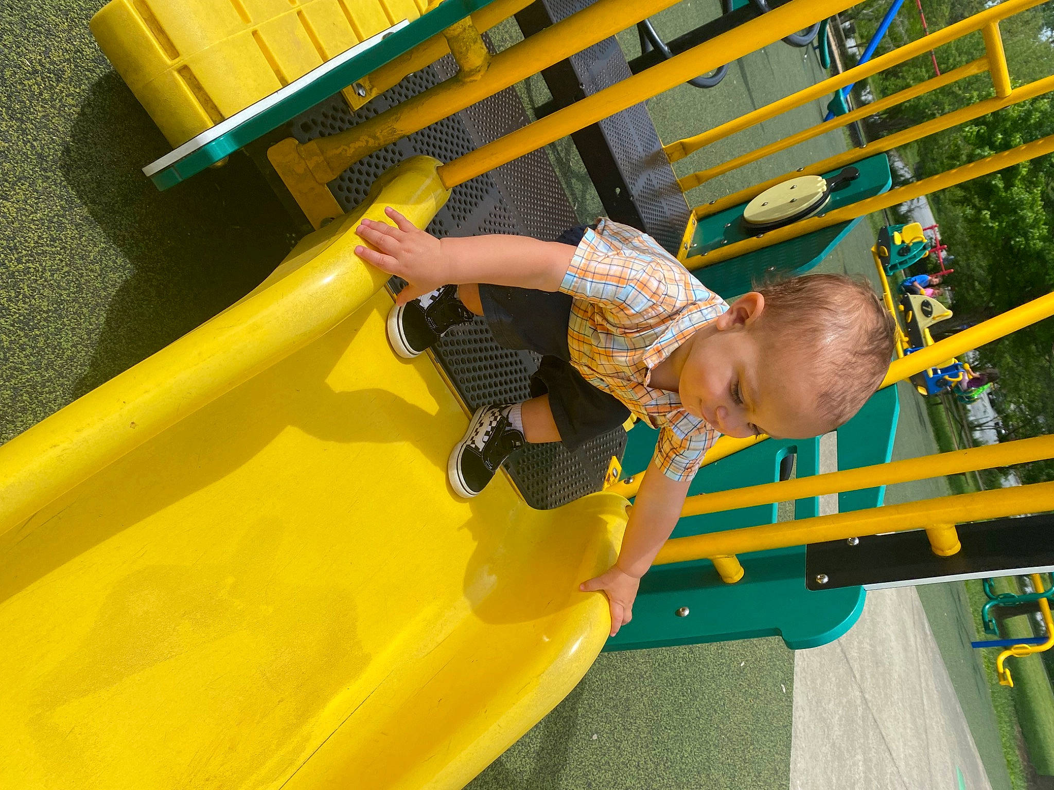 Theodore is registered to the contest to win money with this photo: amusement_park, amusement_ride, baby, baby_toddler_clothing, child, chute, city, fun, leisure, nonbuilding_structure, outdoor_play_equipment, person, play, playground, playground_slide, recreation, toddler, yellow
