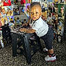 Kyaire joined the competition — help win amazing prizes! toddler, child, baby, stool, indoor, photography, portrait, curious, clothing, sneakers, floor, background, photo_collage, family, people, smiling, standing, polka_dot, black, white