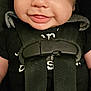Jason is registered to the contest to win money with this photo: baby, smiling, infant, car_seat, harness, black_clothing, red_button, closeup, face, child, cute, safety, straps, person, seat, young, hands, happy, secure, portrait