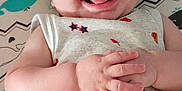 Jason joined the competition — help win amazing prizes! baby, smiling, infant, onesie, patterned_clothing, hands, tongue_out, lying_down, mattress, whale_pattern, zigzag_pattern, cute, happy, child, indoor, closeup, skin, head, face, playful