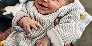 Abby a rejoint le concours — aidez-le/la à gagner de superbes lots ! baby, blanket, bracelets, closeup, clothing, cute, face, hand, happy, holding, infant, jacket, outdoor, patterned_pants, person, portrait, smiling, tattoo, warm_clothes, yellow_pants