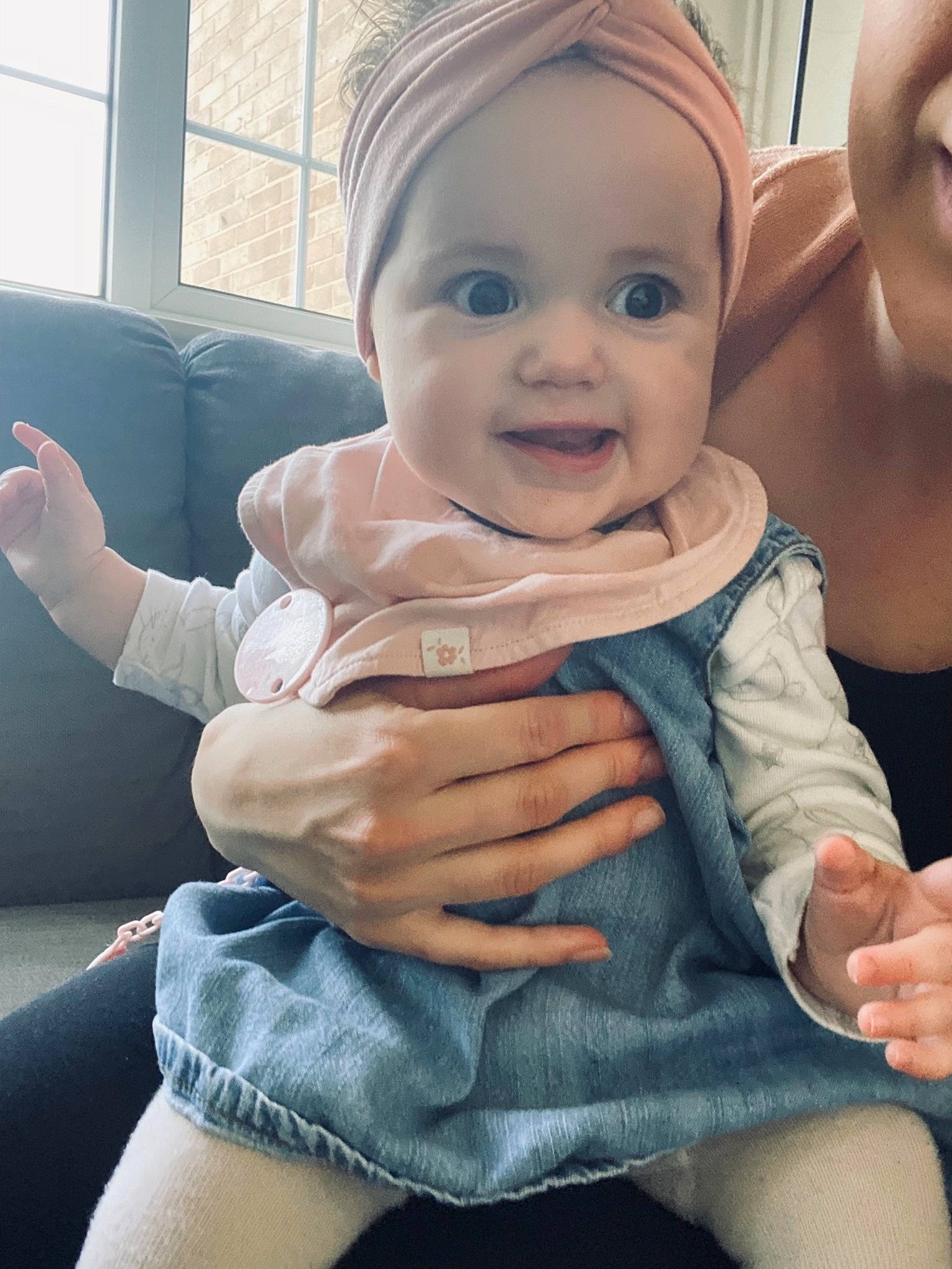 Mia is registered to the contest to win money with this photo: baby_toddler_clothing, cheek, comfort, cool, eye, finger, gesture, hand, happy, head, headwear, human_body, joint, lip, mouth, muscle, nose, person, shoulder, skin