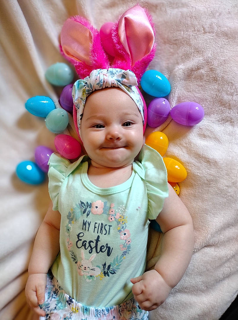 Emerald is registered to the contest to win money with this photo: baby, baby_toddler_clothing, child, costume_hat, face, fun, happy, head, headgear, headpiece, headwear, magenta, party_supply, person, pink, purple, skin, smile, textile, toddler