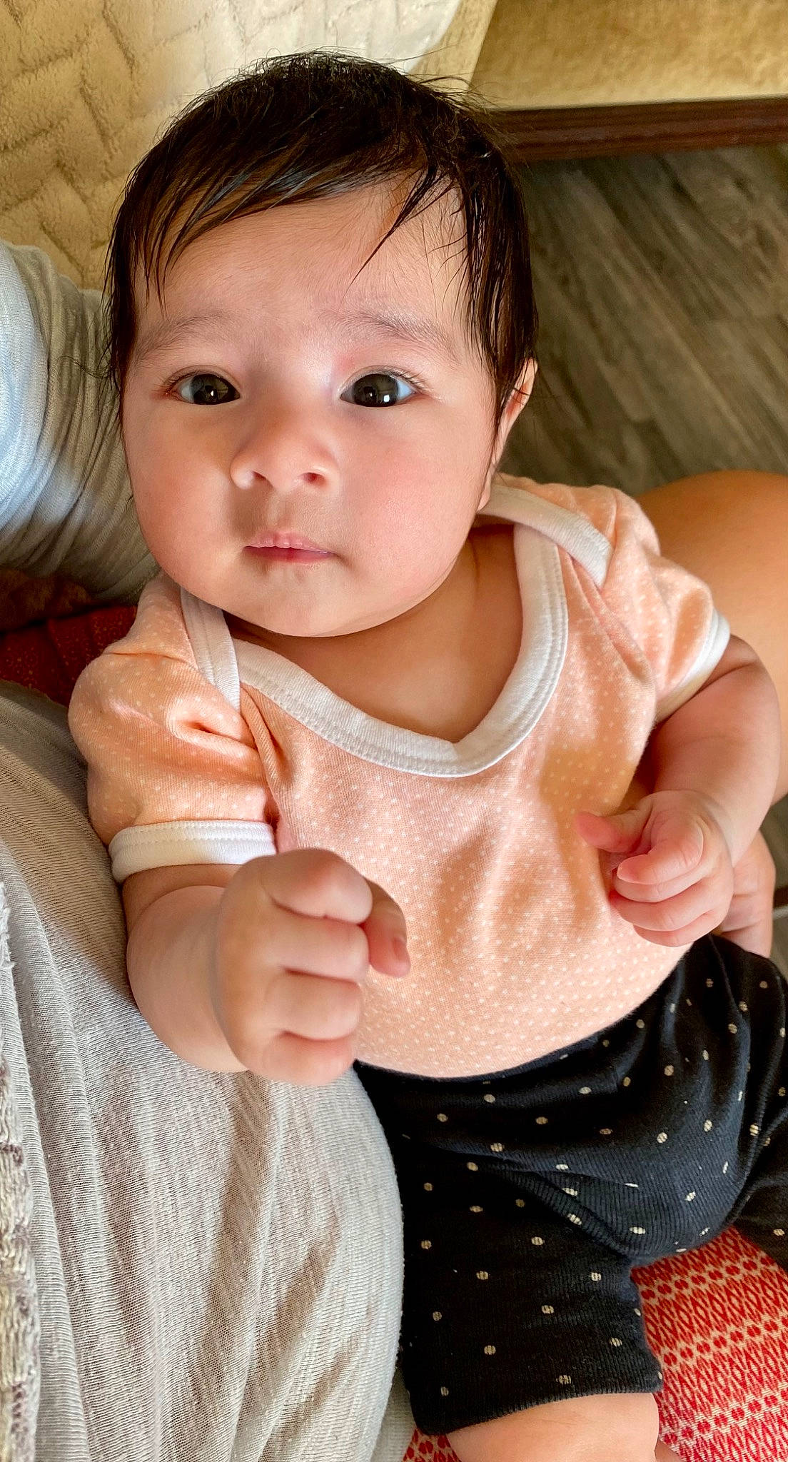 Avery is registered to the contest to win money with this photo: arm, baby, baby_toddler_clothing, cheek, dress, eye, eyelash, finger, gesture, hand, happy, human_body, iris, lip, neck, nose, person, skin, sleeve, thumb