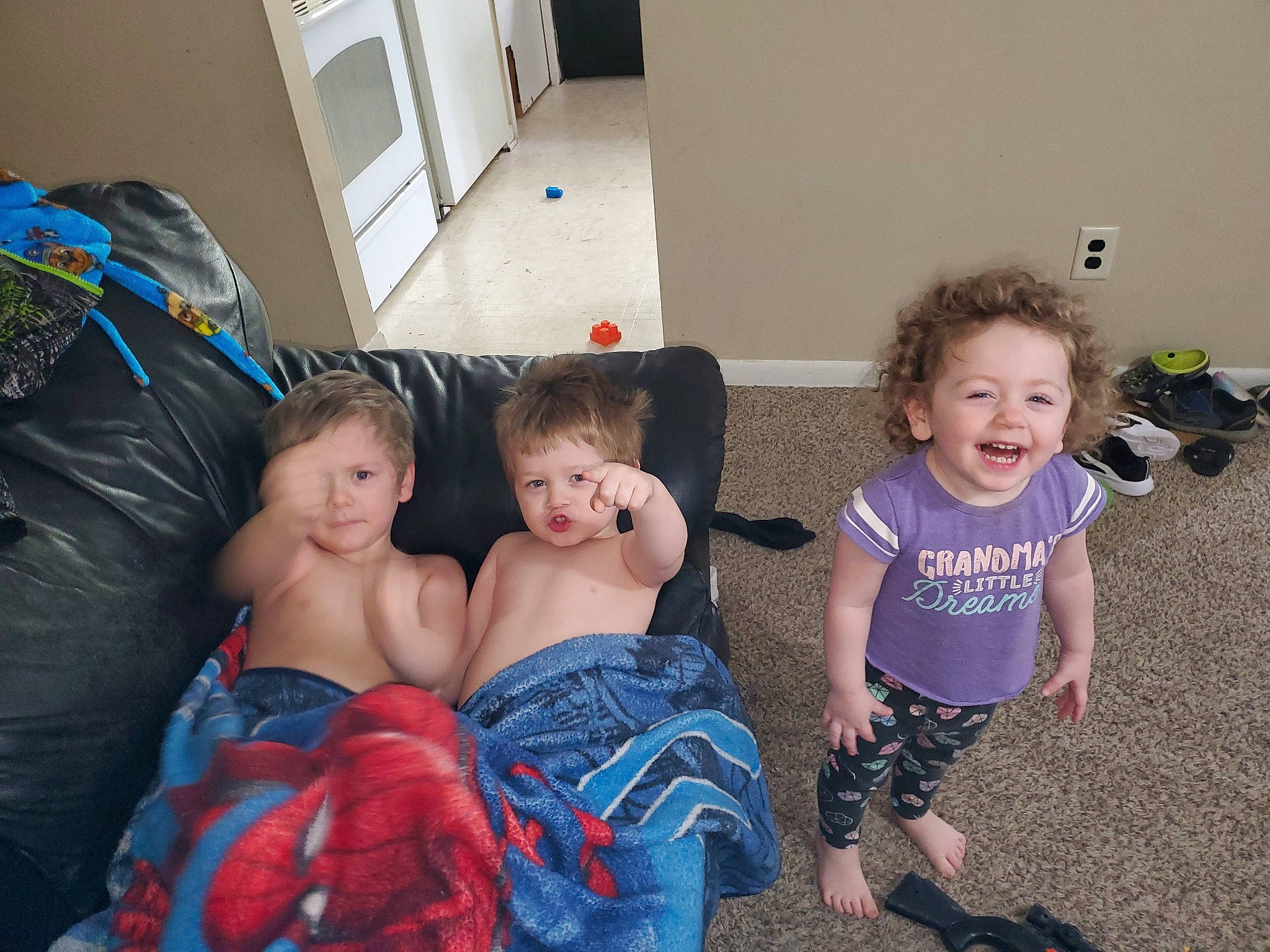 Liam is registered to the contest to win money with this photo: child, electronic_device, eye, face, family, fun, happy, head, interaction, iris, joy, lap, people, person, play, room, sibling, sitting, skin, smile