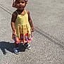 toddler, child, outdoor, sunny, dress, hat, sandals, shadow, pavement, colorful, floral, standing, person, summer, young, cute, smiling, sunlight, casual, happy
