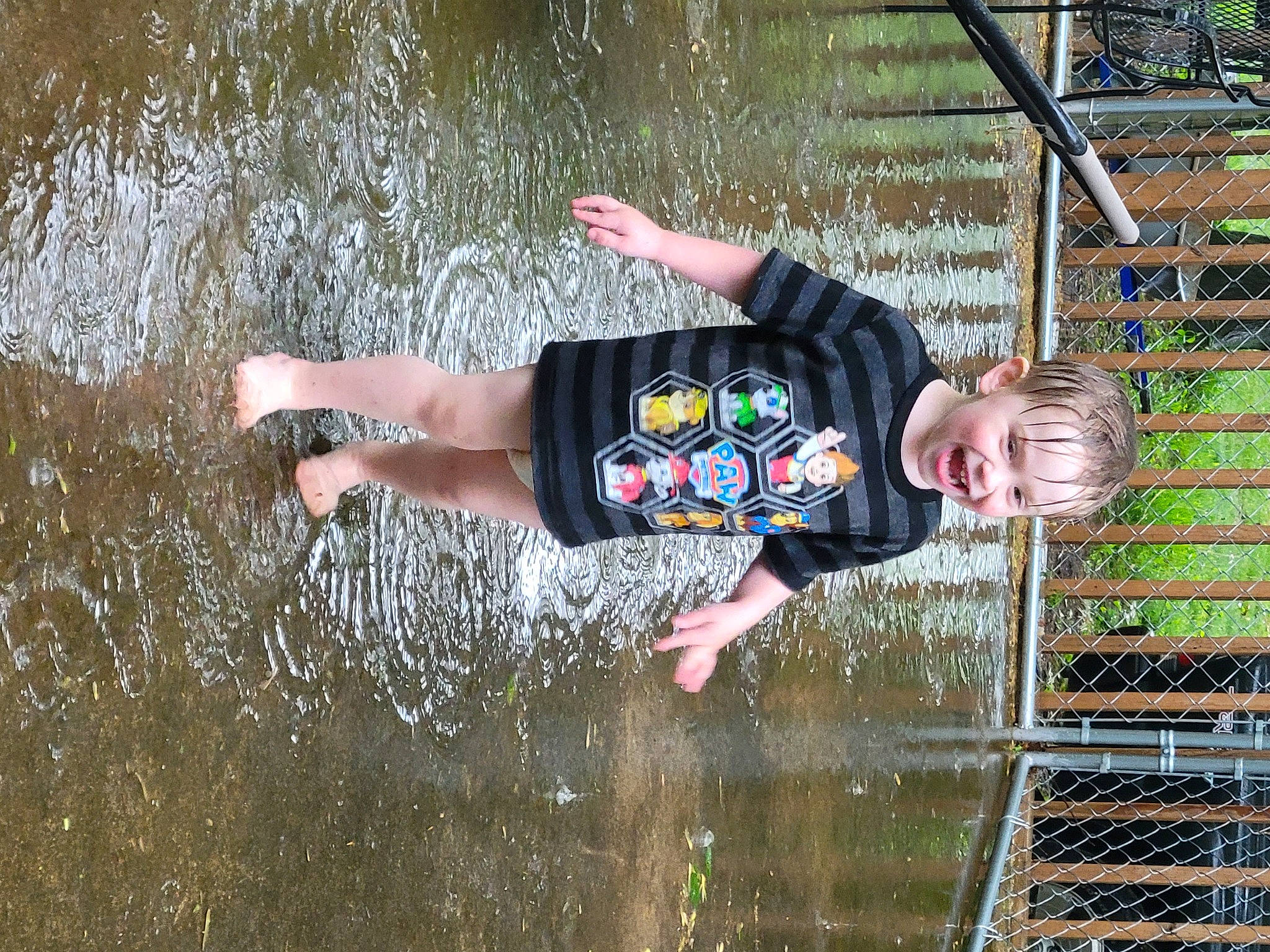 Archer is registered to the contest to win money with this photo: adventure, child, fun, grass, happy, lake, leisure, people_in_nature, person, plant, play, puddle, recreation, reflection, shorts, stream, t_shirt, toddler, tree, water