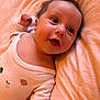 Méline participe au concours pour gagner de l'argent avec cette photo : baby, infant, onesie, cute, smile, face, eyes, fist, bed, bedding, soft, child, newborn, lying_down, warm_colors, skin, cheeks, hair, expression, indoors