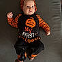baby, infant, halloween, costume, pumpkin, orange, black, clothing, cute, face, headwear, lying_down, fabric, sock, child, portrait, holiday, celebration, expression, person