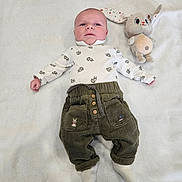 Malo a rejoint le concours — aidez-le/la à gagner de superbes lots ! animal_prints, baby, blanket, bunny, child, clothing, corduroy_pants, cozy, cute, head, indoor, infant, lying_down, plush_toy, portrait, smiling, soft_texture, toy, white_shirt, young