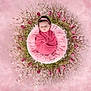 newborn, baby, pink, flower_arrangement, fluffy_cushion, headband, portrait, wrapped, soft_background, studio_photography, infant, peaceful, decorative, closeup, cute, child, floral, artistic, warm, adorable