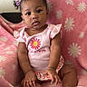 Malyiah joined the competition — help win amazing prizes! adorable, baby, blanket, child, clothing, curious, cute, daisy, face, flower_pattern, hair_clips, indoors, infant, pigtails, pink, portrait, sitting, smile, soft_texture, young_child